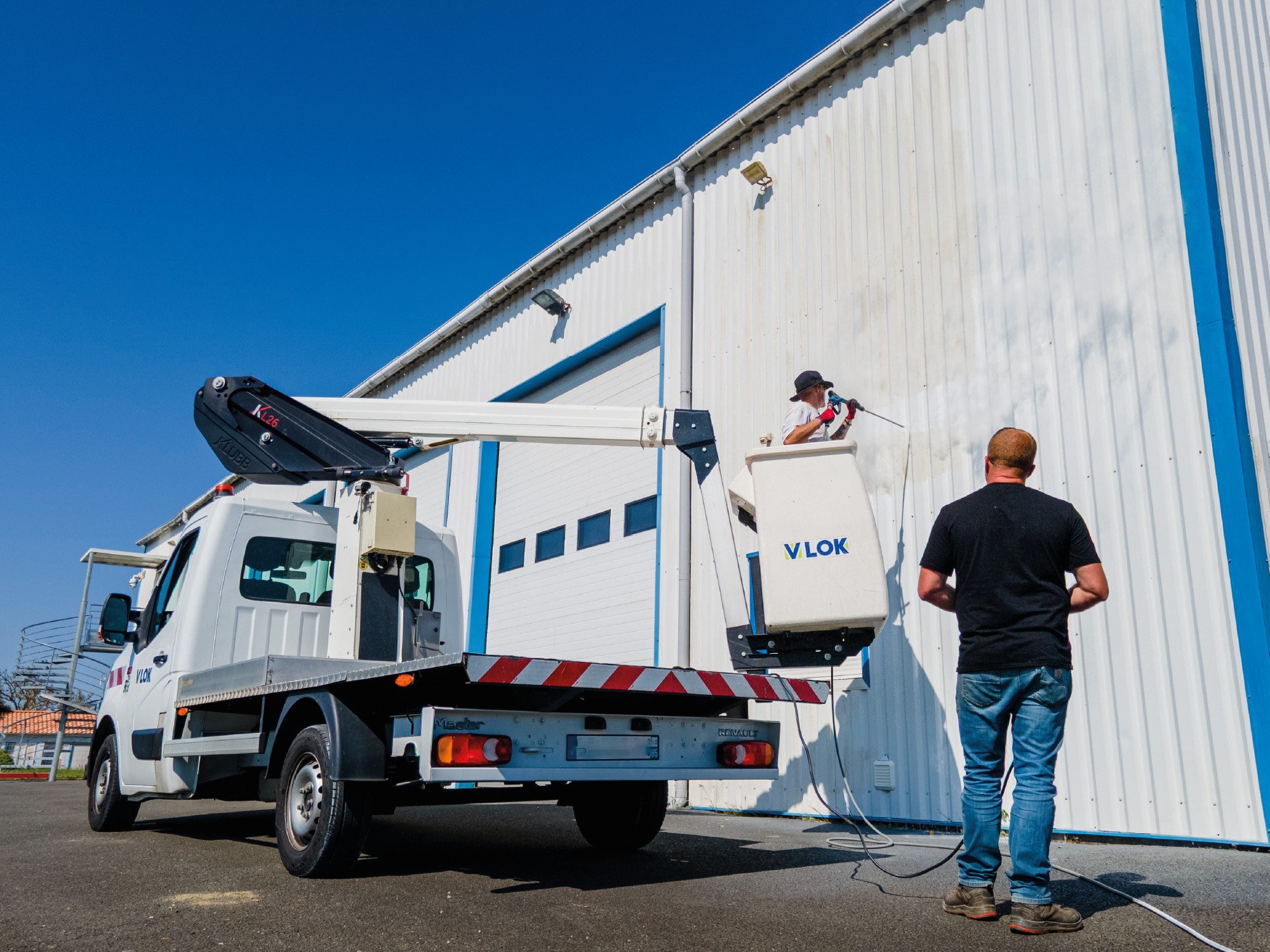 Photo d'une entreprise de nettoyage de façade toiture à l'aide d'un camion nacelle